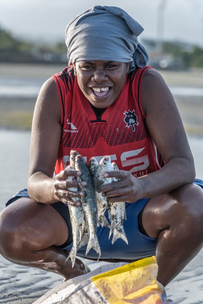 A female iTaukei fisher with her catch at the Suva foreshore.